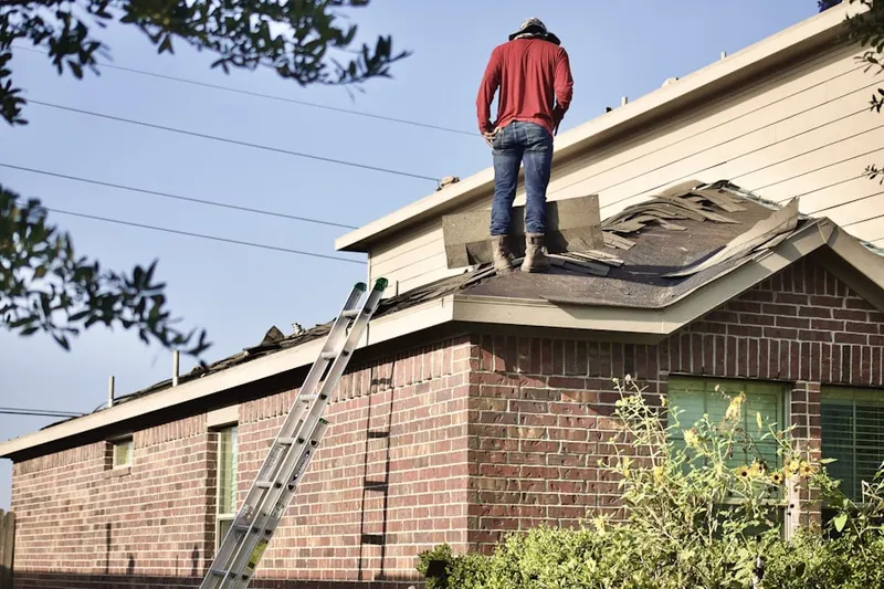 Professional roofer working on a residential roof in Willow Wood Village